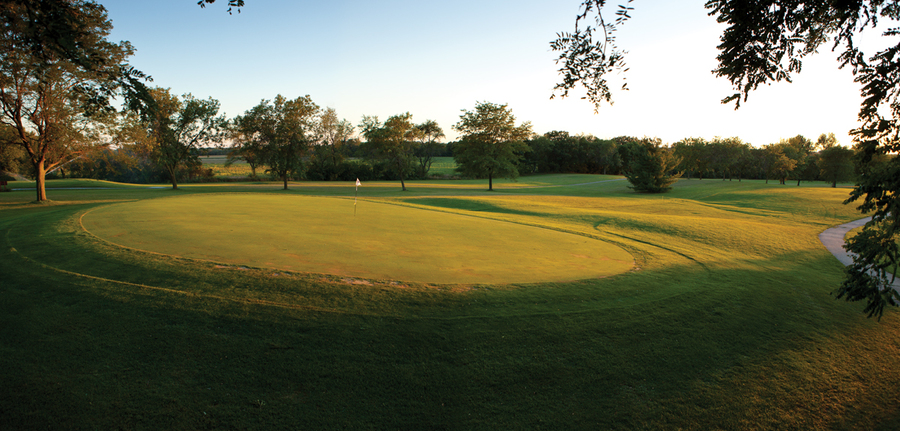 View of a hole on the course at sunset at Coachman's Golf Resort